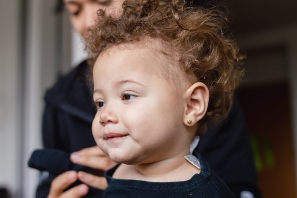 portrait beautiful caucasian baby relaxed at home with her father behind her, lifestyle concept, copy space