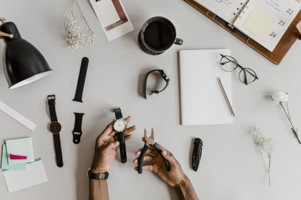 Horologist fixing a watch with pliers